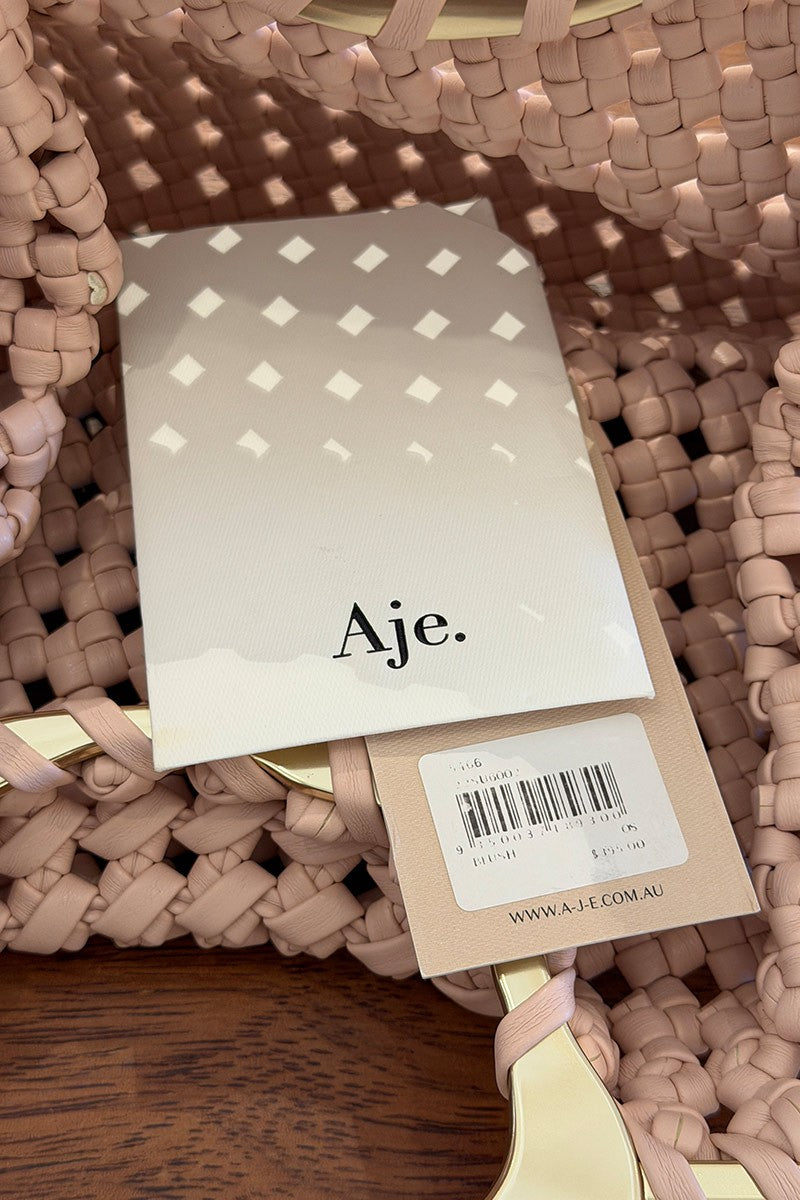 Aje blush woven leather clutch (RRP $395)